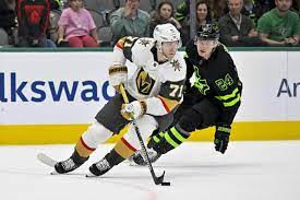 Golden Knights forward William Karlsson (left) skates with the puck against Stars forward Roope Hintz.