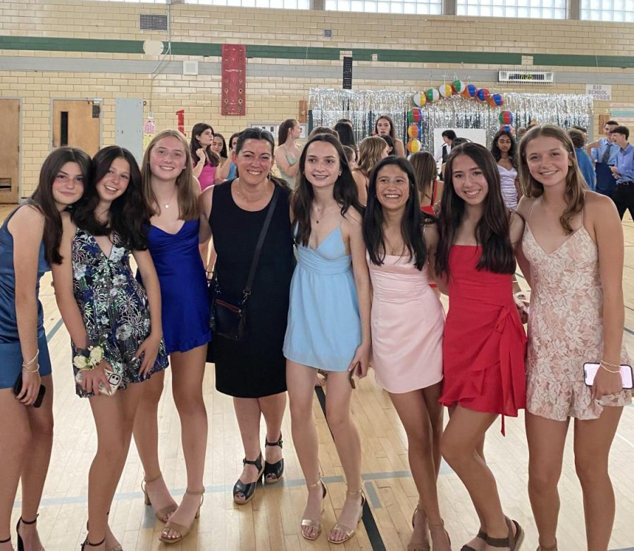 Eighth graders pose at the eighth grade dance with chaperone and teacher Mrs. Erin Meade.