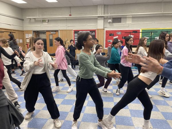 Sixth grader Zoe Boyd and Delaney Maiorana are front and center during a rehearsal of Let the sun shine on for Frozen. 