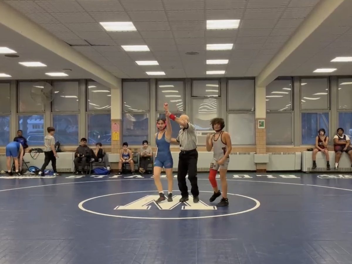 EIS 8th grader Laia Colet-Rams wins a wrestling match against a male wrestler from Union, NJ.