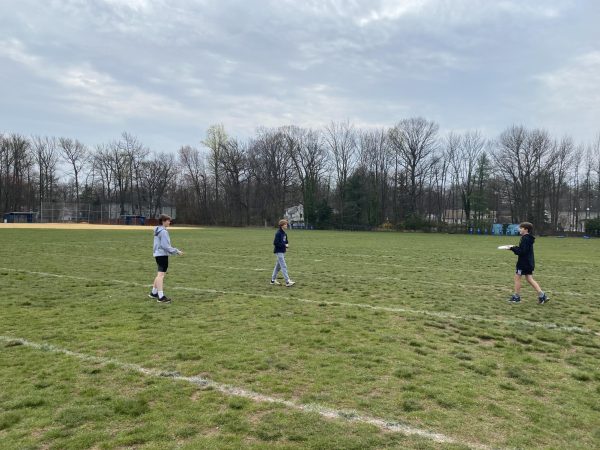 Here are students playing frisbee on the grass field behind EIS. Many believe this field should be converted to turf. 