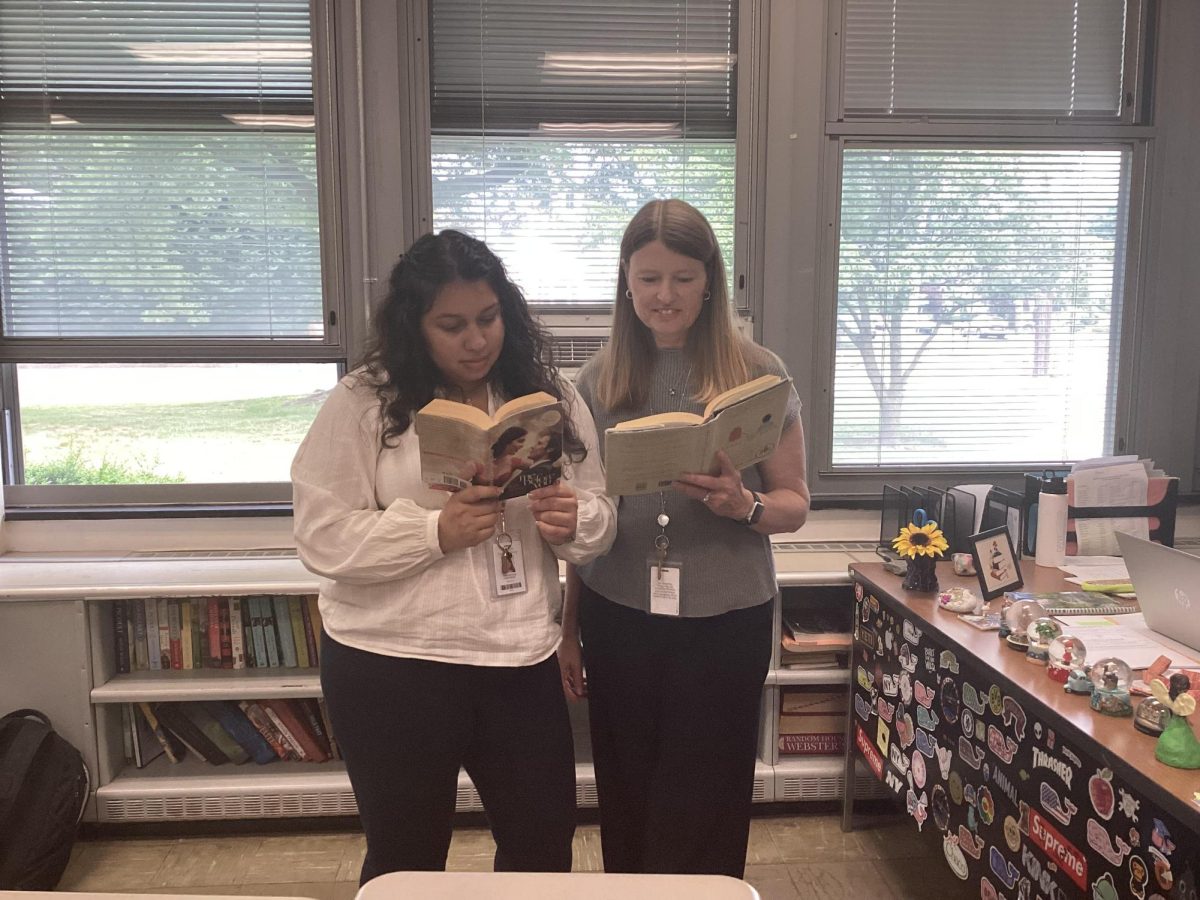 Special Education teacher Ms. Stephanie Grajales looking through some books with Language Arts teacher Mrs. Kim Swenson. 