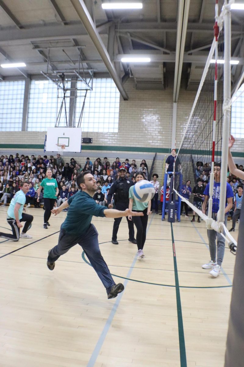 7th Language Arts teacher Mr. Marc Lazarow leaps for a ball during the student teacher volleyball game--one of the most loved activities of the year.