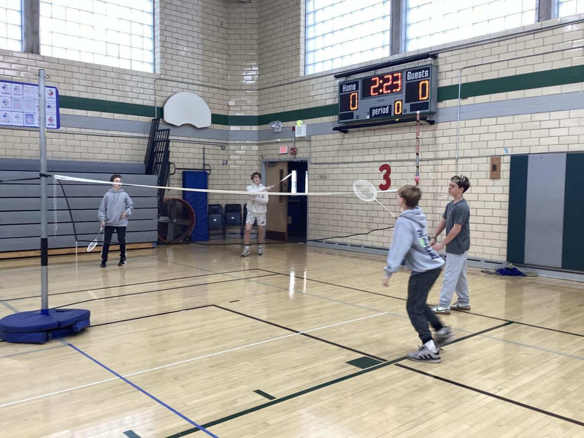 The eighth grade boys playing badminton during EIS Physical Education class benefit from physical activity during the school day. 