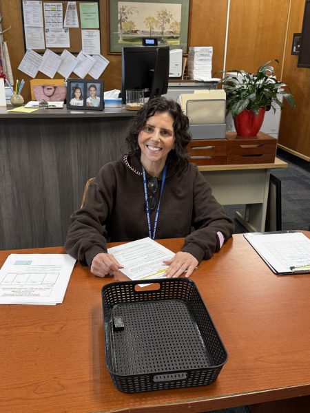Child Study Team member Ms. Melissa Greenwald filing paperwork for one of her students attending ESY this summer.