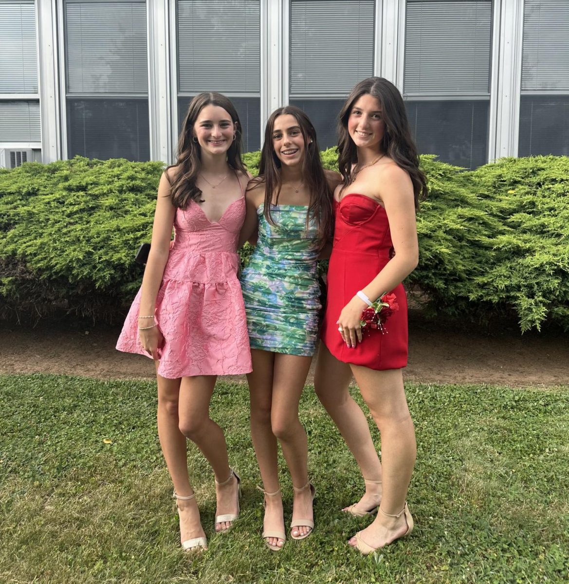 Last year's eighth graders Fiona Brown, Sadie Soriero, and Nicole DiMattina posing in front of EIS before the dance. 