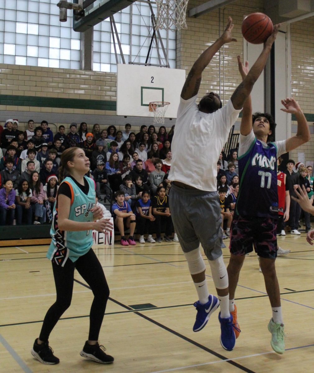 Head custodian Mr. Kevin Womack always dunks during the annual student-teacher basketball game. 