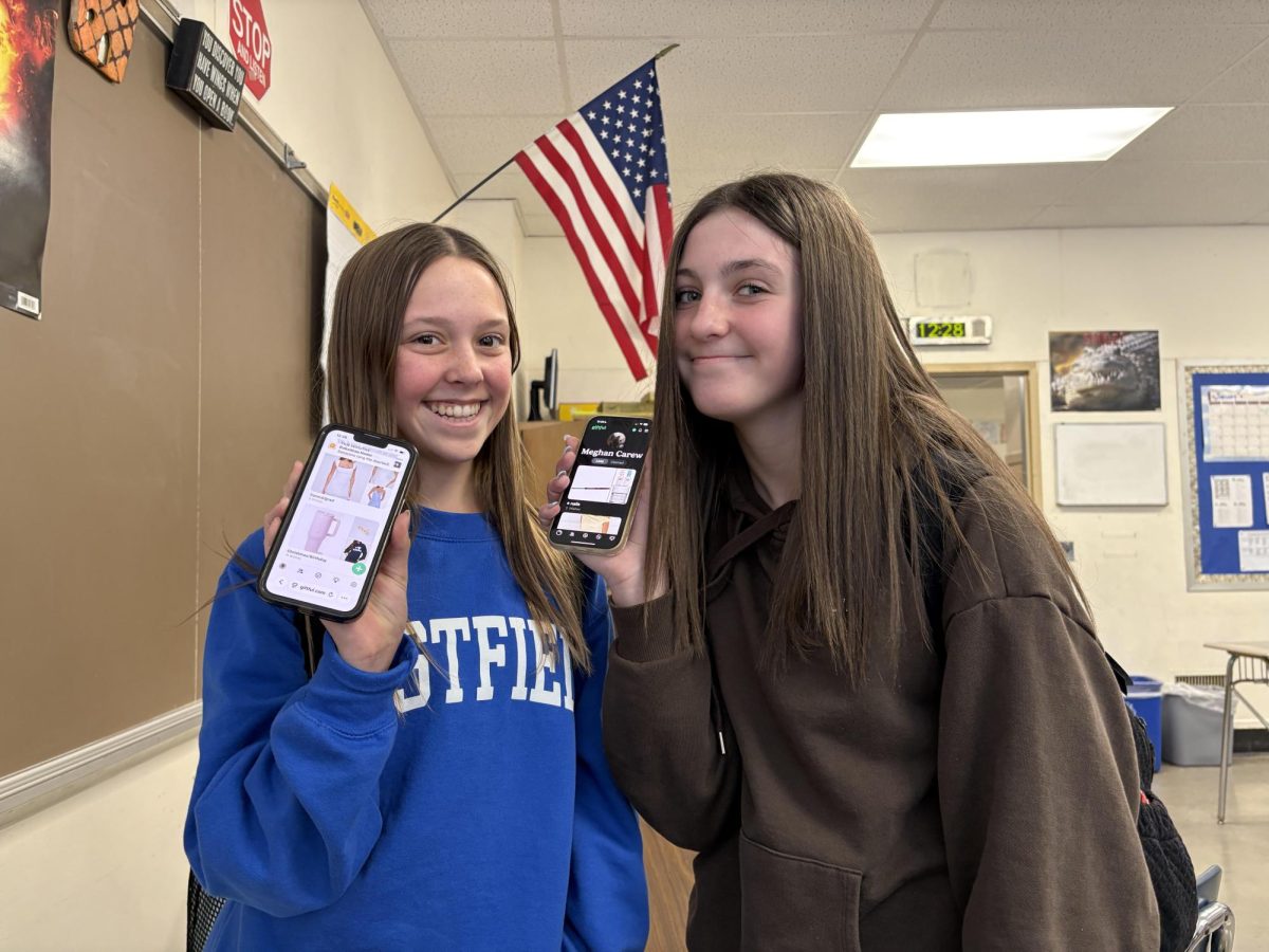 Eighth graders Brynn Rabaddeau and Meghan Carew both use Giftful on their phones to collect gift options. 
