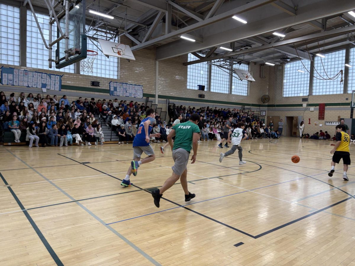 Teachers like Mr. Stephen Markowski are seen here running up the court against the eighth grade team. 