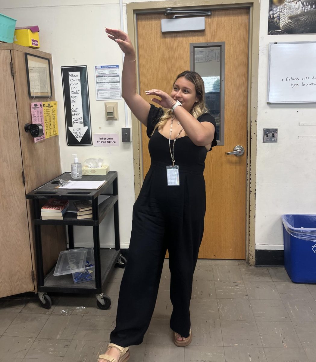 Special Education teacher Ms. Stephanie Grajales demonstrates one of the famous dance moves in the show The Dougherty Dozen.